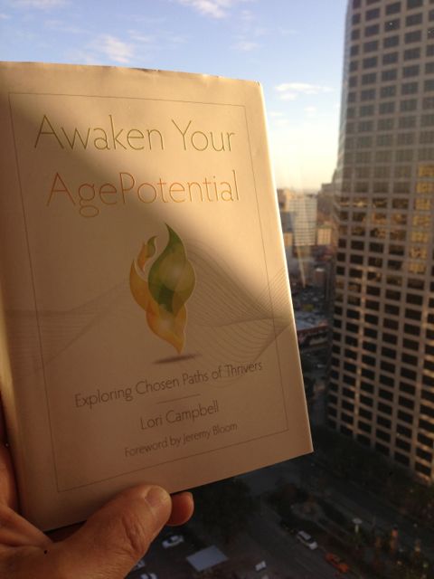Lori Campbell, Gerontologist, best selling book, Awaken Your AgePotential jeff noel holding a copy of Awaken Your AgePotential at Hyatt Regency New Orleans