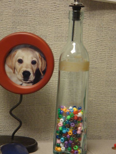 Bottle 1/2 full of beads representing weekend with a child