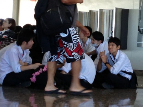 Uniformed Japanese school boys and an adult in aloha pants