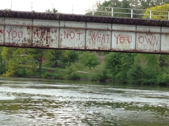 Old river bridge with profound graffiti message 