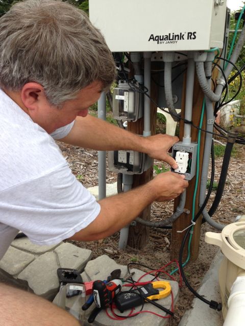 Florida electrician working on pool equipment