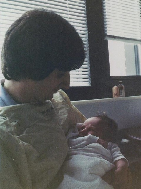 Newborn baby in father's arms