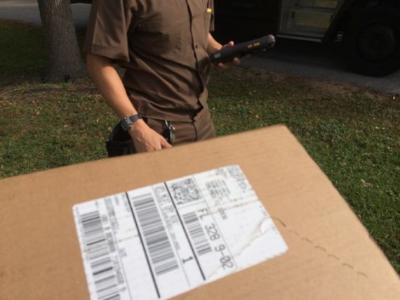 UPS delivery driver, truck and package