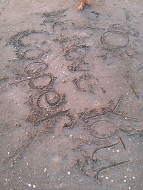 Loving message written in the beach sand