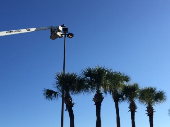 High lift replacing parking lot lightbulb