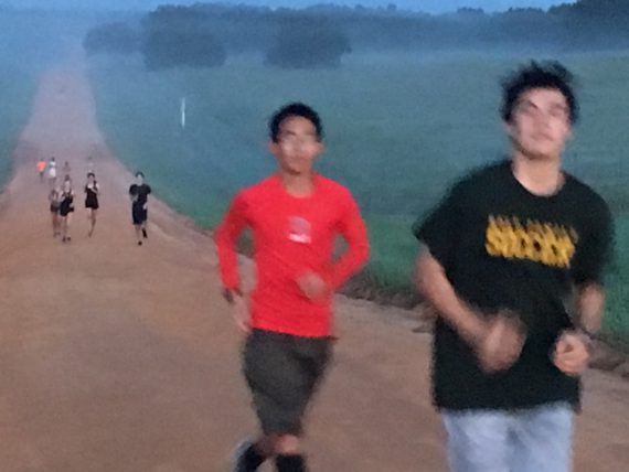 Runners on red dirt road