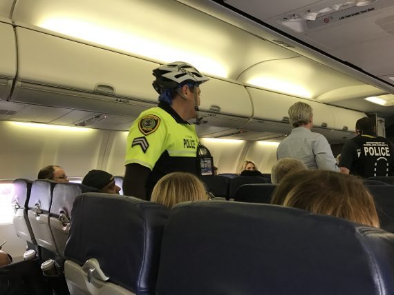 Police escorting an airline passenger.